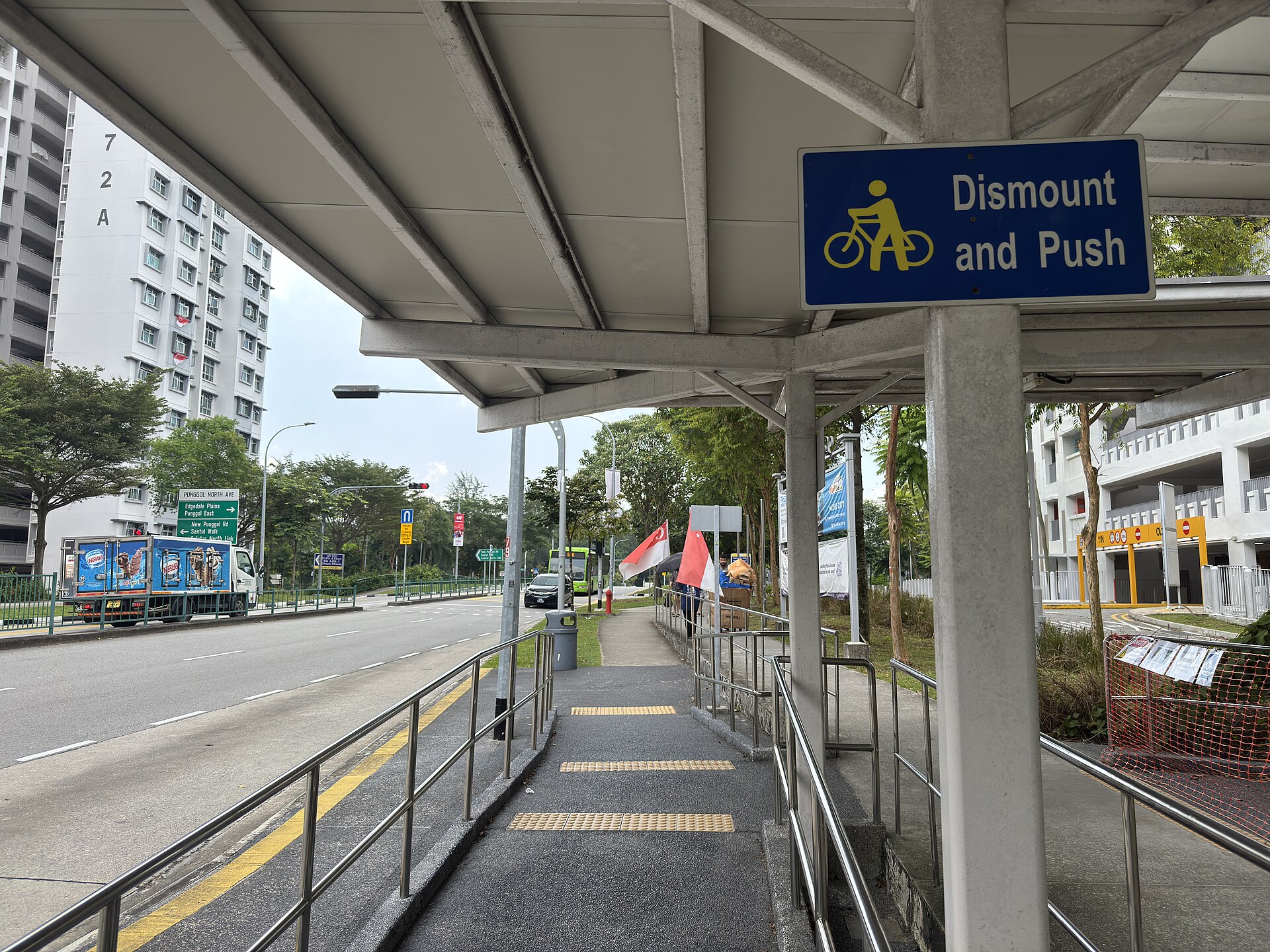 Covered walkway leading to a bus stop near Block 670A